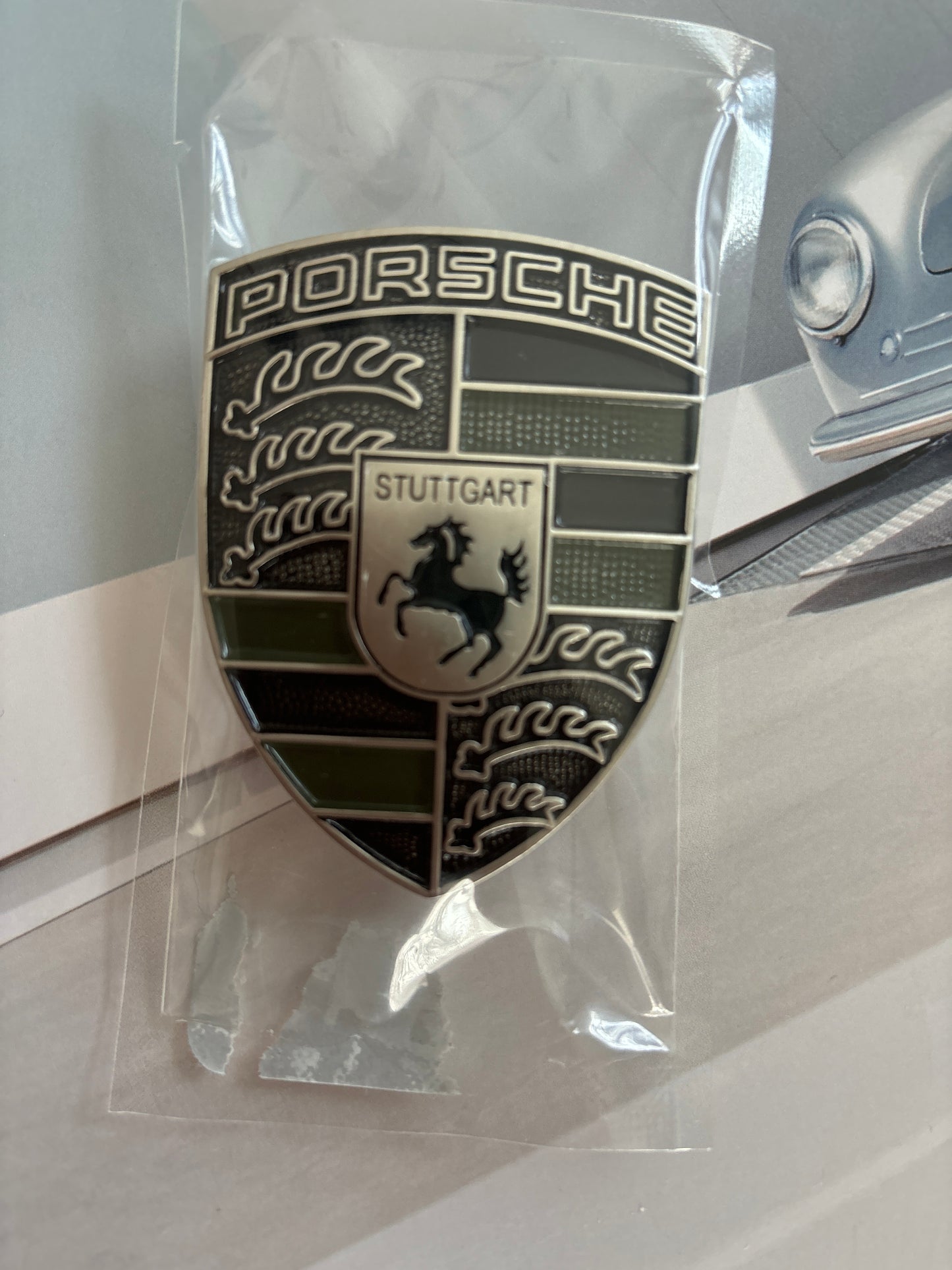 Black and steel look Porsche hood badge